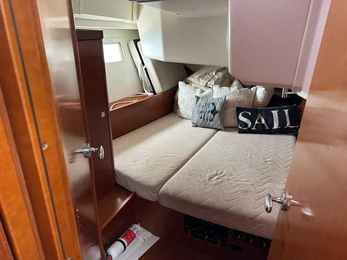 Traveller Two Yacht Photos Pics Cozy cabin interior of 2012 Beneteau Oceanis 45 sailboat with comfortable bedding.
