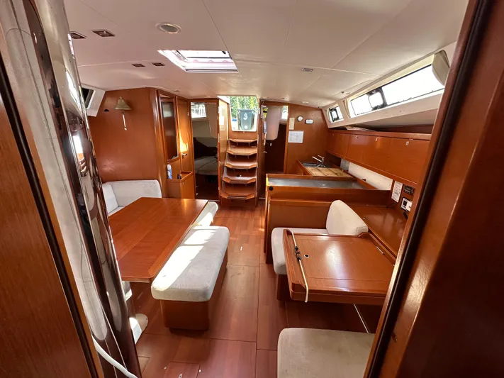Traveller Two Yacht Photos Pics Interior of 2012 Beneteau Oceanis 45 yacht, featuring wood finishes and spacious seating area.