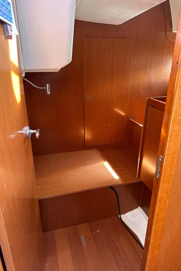 Traveller Two Yacht Photos Pics Interior cabin of a 2012 Beneteau Oceanis 45 sailboat, featuring wooden paneling.