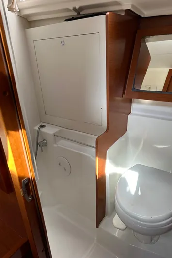 Traveller Two Yacht Photos Pics 2012 Beneteau Oceanis 45 bathroom with wooden accents and compact design.