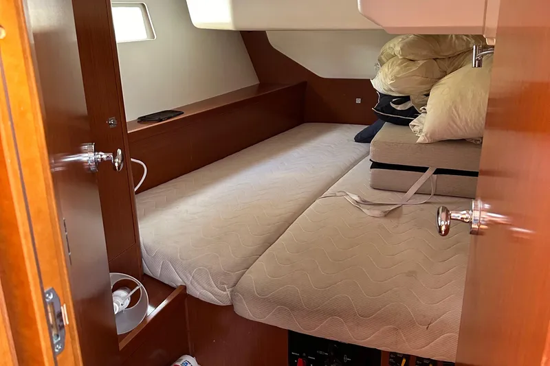 Traveller Two Yacht Photos Pics Cozy cabin interior of 2012 Beneteau Oceanis 45 sailboat with bed and storage.