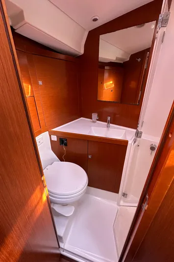 Traveller Two Yacht Photos Pics Beneteau Oceanis 45 (2012) yacht bathroom with wooden finish and modern fixtures.