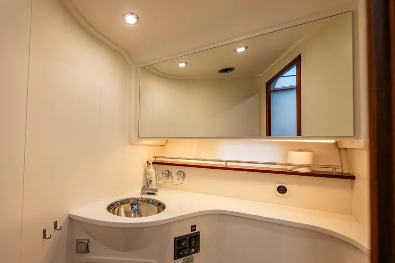 Crazy Love Yacht Photos Pics Luxurious bathroom interior of 2023 Nimbus 405 Coup&eacute; yacht with modern fixtures.