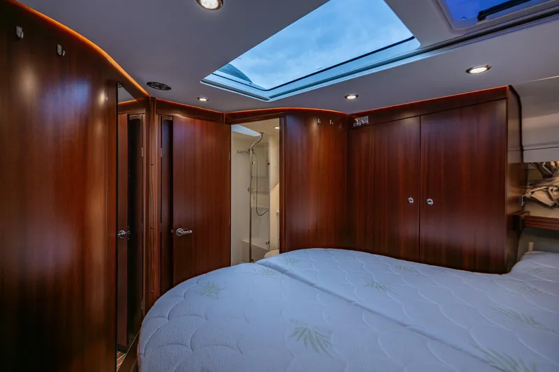 Crazy Love Yacht Photos Pics Luxurious interior of 2023 Nimbus 405 Coup&eacute; yacht with skylight and wooden finishes.
