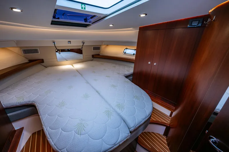 Crazy Love Yacht Photos Pics Luxurious interior cabin of 2023 Nimbus 405 Coup&eacute; yacht with elegant wood finishes.