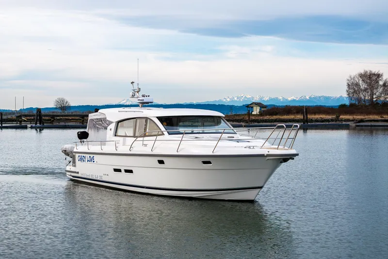 Crazy Love Yacht Photos Pics Nimbus 405 Coup&eacute; 2023 cruising on calm waters with scenic mountain backdrop.