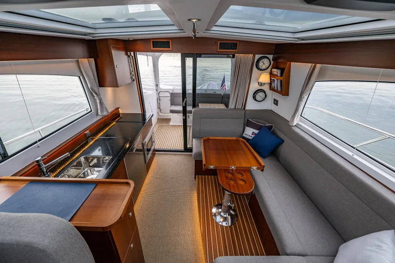 Crazy Love Yacht Photos Pics Luxurious interior of 2023 Nimbus 405 Coup&eacute; yacht with modern kitchen and seating area.