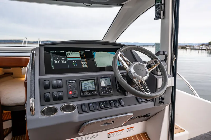 Crazy Love Yacht Photos Pics Helm of 2023 Nimbus 405 Coup&eacute; with advanced navigation controls and steering wheel.