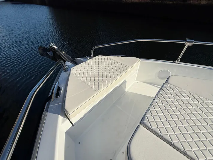  Yacht Photos Pics 2025 Jeanneau DB/37 OB boat with cushioned seating on deck by the water.