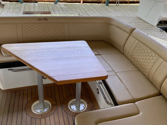  Yacht Photos Pics Luxurious seating area on 2018 Sea Ray Sundancer 350 yacht with wooden table.