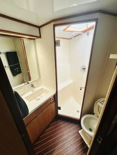  Yacht Photos Pics 1988 Bertram 54' yacht bathroom with shower, sink, and toilet.