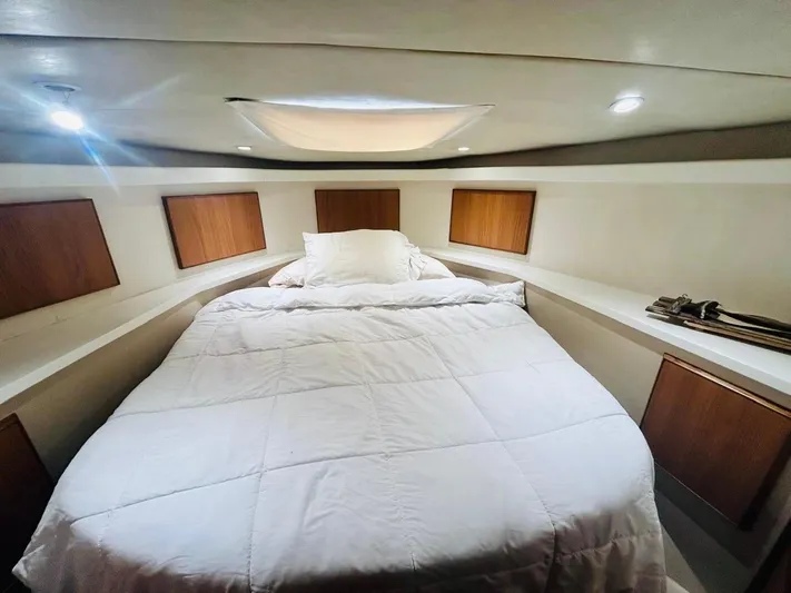  Yacht Photos Pics Luxurious bedroom interior of 1988 Bertram 54' yacht with cozy bedding.