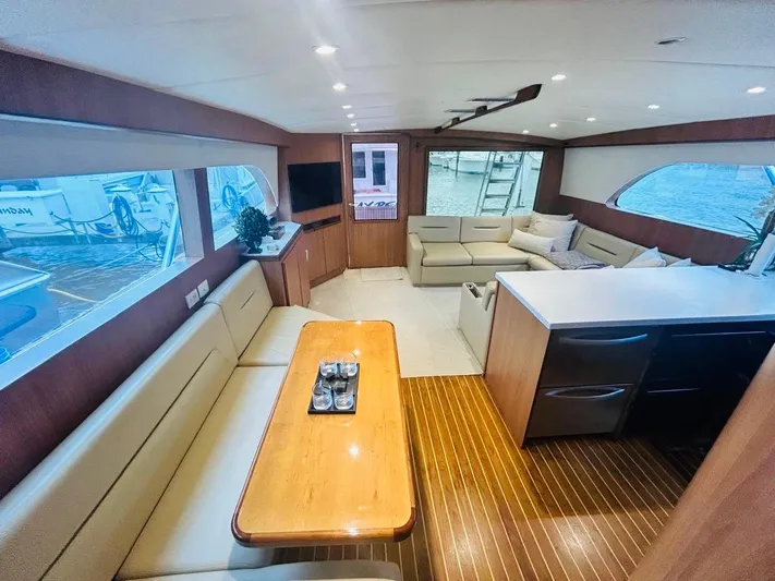  Yacht Photos Pics Luxurious interior of a 1988 Bertram 54' yacht with elegant seating and wood finishes.