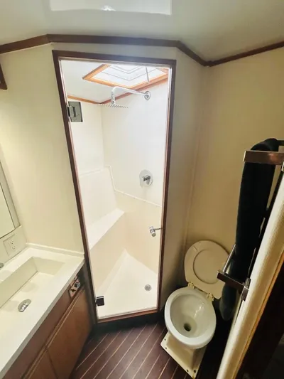  Yacht Photos Pics 1988 Bertram 54' yacht bathroom with shower, toilet, and sink.