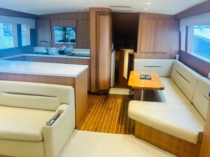  Yacht Photos Pics Luxurious interior of a 1988 Bertram 54' yacht with modern kitchen and seating area.