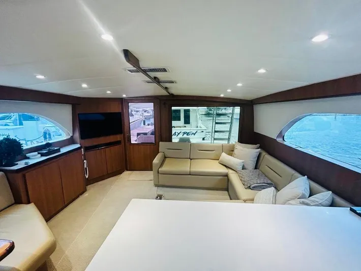  Yacht Photos Pics Luxurious interior of 1988 Bertram 54' yacht with modern furnishings and large windows.