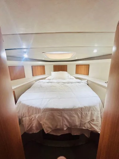  Yacht Photos Pics Luxurious bedroom interior of 1988 Bertram 54' yacht with cozy bedding.