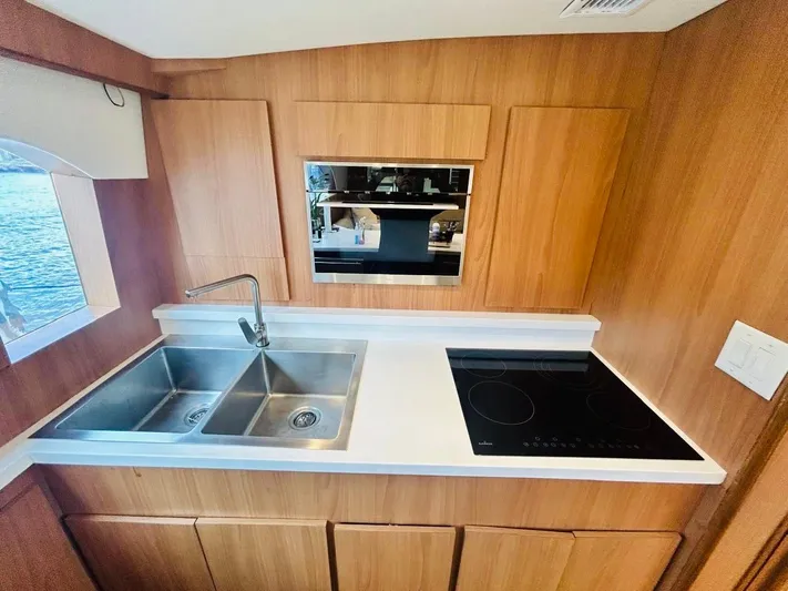  Yacht Photos Pics 1988 Bertram 54' yacht kitchen with dual sink and electric cooktop.