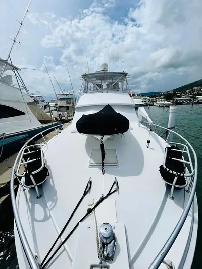  Yacht Photos Pics 1988 Bertram 54' yacht docked at marina under cloudy sky.