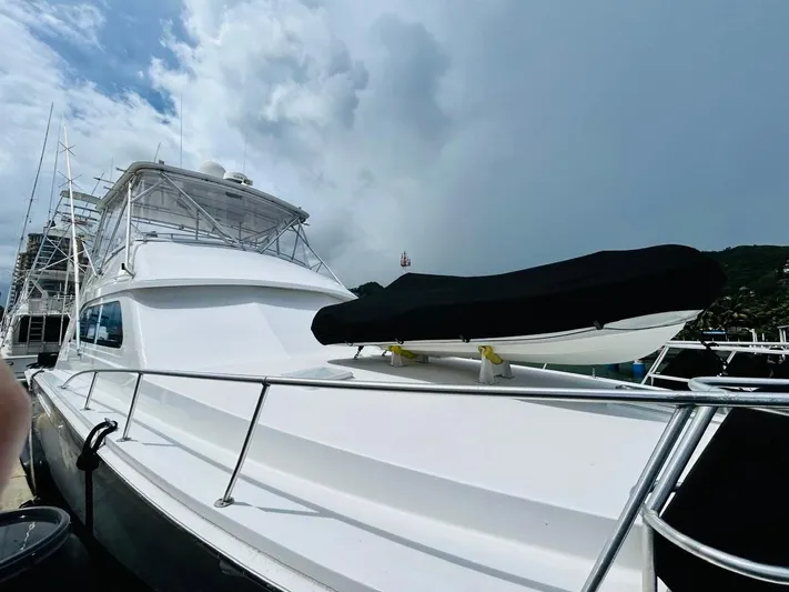  Yacht Photos Pics 1988 Bertram 54' yacht docked under cloudy sky.