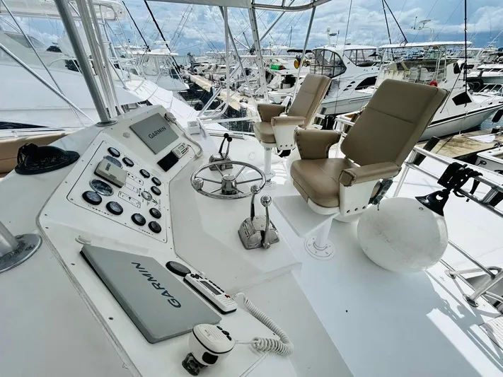  Yacht Photos Pics Cockpit of 1988 Bertram 54' yacht with Garmin navigation, docked at marina.