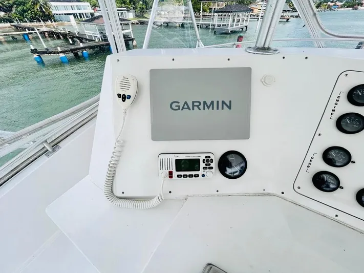  Yacht Photos Pics Bertram 54' 1988 yacht helm with Garmin navigation system and radio controls.