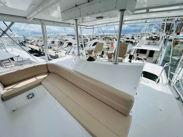  Yacht Photos Pics 1988 Bertram 54' yacht interior with seating, docked among other boats.