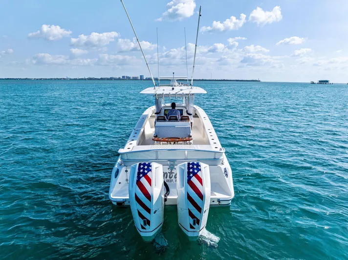 Vantage Yacht Photos Pics 2015 Bahama Center Console boat on open water, featuring patriotic-themed outboard motors.