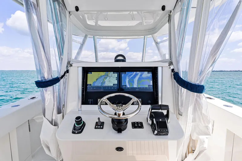 Vantage Yacht Photos Pics 2015 Bahama Center Console boat helm with dual navigation screens on open water.