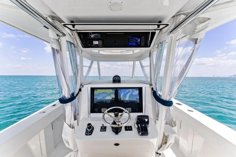 Vantage Yacht Photos Pics 2015 Bahama Center Console boat interior with navigation screens, steering wheel, and ocean view.