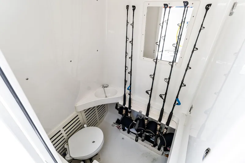 Vantage Yacht Photos Pics 2015 Bahama Center Console interior with fishing rods and compact toilet.