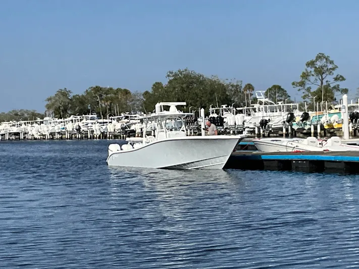  Yacht Photos Pics 2020 Yellowfin 36 Offshore boat docked, surrounded by other boats.