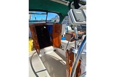 1999 Caliber 40LRC yacht cockpit with wooden doors and steering wheel.