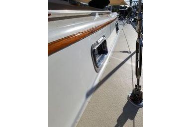 1999 Caliber 40LRC sailboat deck with polished wood trim and stainless steel fittings.