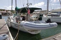 Sailboat docked at marina, 1999 Caliber 40LRC with inflatable dinghy.