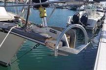 1999 Caliber 40LRC sailboat docked in marina, featuring stainless steel arch and equipment.