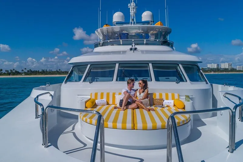 I Love This Boat Yacht Photos Pics Couple relaxing on 2002 Christensen Tri Deck yacht with striped cushions, ocean view.