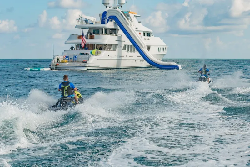 I Love This Boat Yacht Photos Pics Jet skis near 2002 Christensen Tri Deck yacht with slide on ocean.