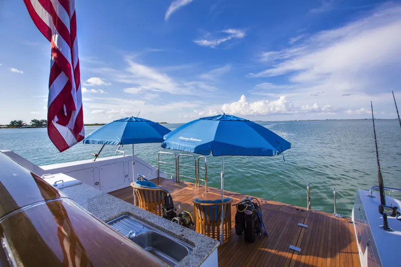 I Love This Boat Yacht Photos Pics Luxurious 2002 Christensen Tri Deck yacht deck with blue umbrellas and ocean view.