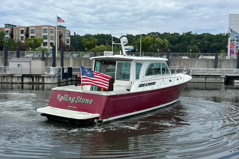 Rolling Stone Yacht Photos Pics 2017 Back Cove 41 boat with American flag, docked in a marina.