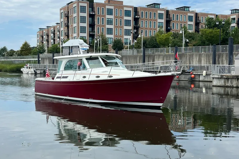 Rolling Stone Yacht Photos Pics 2017 Back Cove 41 boat docked near modern waterfront buildings.