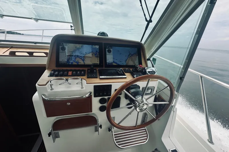 Rolling Stone Yacht Photos Pics Helm of 2017 Back Cove 41 boat with navigation screens and steering wheel.