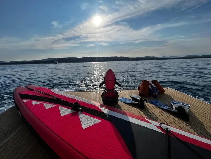  Yacht Photos Pics Red paddleboard on Mondomarine Custom yacht deck, 1995, with ocean view and sunlit sky.