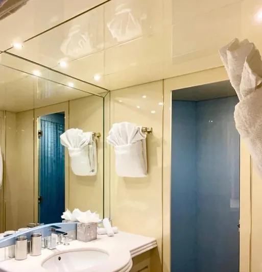  Yacht Photos Pics Luxurious bathroom on 1995 Mondomarine Custom yacht, featuring elegant fixtures and mirrored walls.