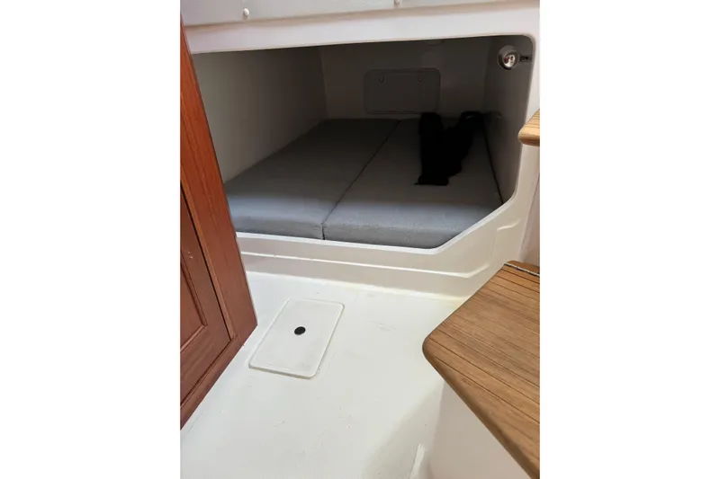  Yacht Photos Pics 2024 NorthCoast 285 HT cabin interior with wooden accents and cushioned seating.