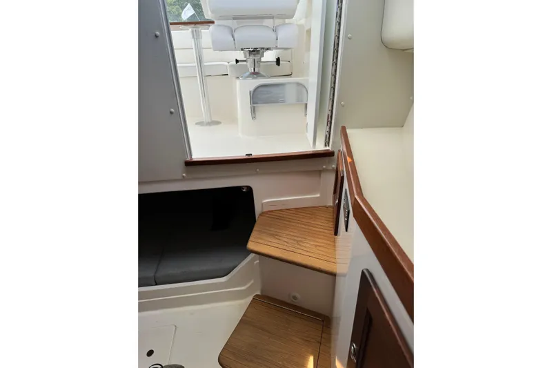  Yacht Photos Pics 2024 NorthCoast 285 HT interior with wooden steps and white seating.