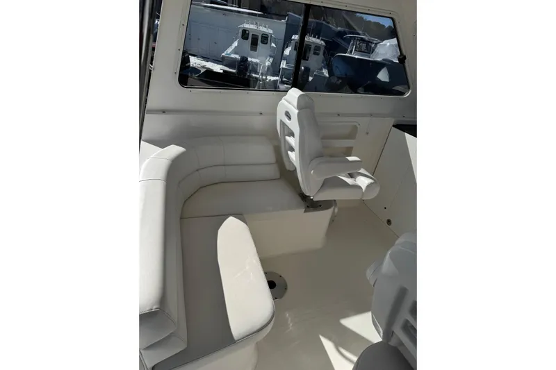  Yacht Photos Pics Interior of 2024 NorthCoast 285 HT boat with white seating and windows.