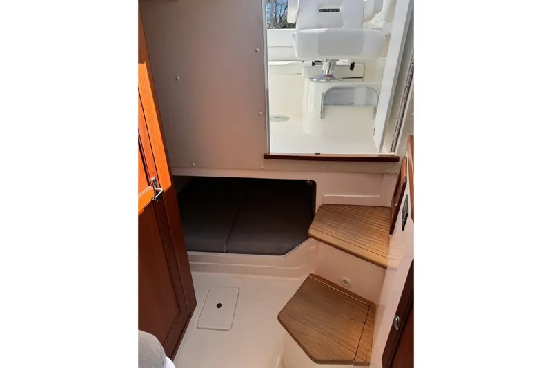  Yacht Photos Pics 2024 NorthCoast 285 HT cabin interior with wooden steps and seating area.