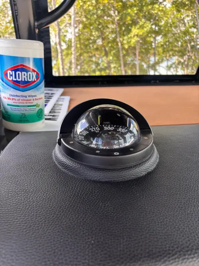  Yacht Photos Pics Compass on 2024 Sea Pro 322 DLX Offshore boat dashboard, with Clorox wipes nearby.