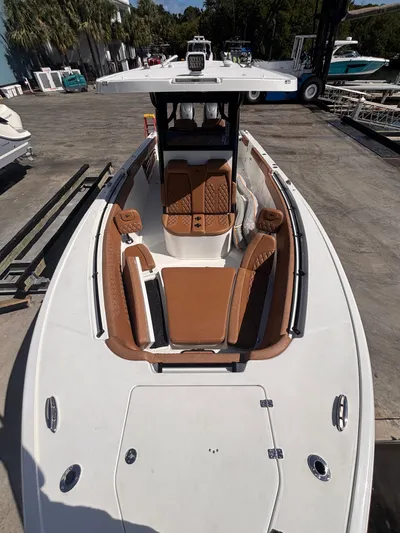  Yacht Photos Pics 2024 Sea Pro 322 DLX Offshore boat with brown seating, docked outdoors.